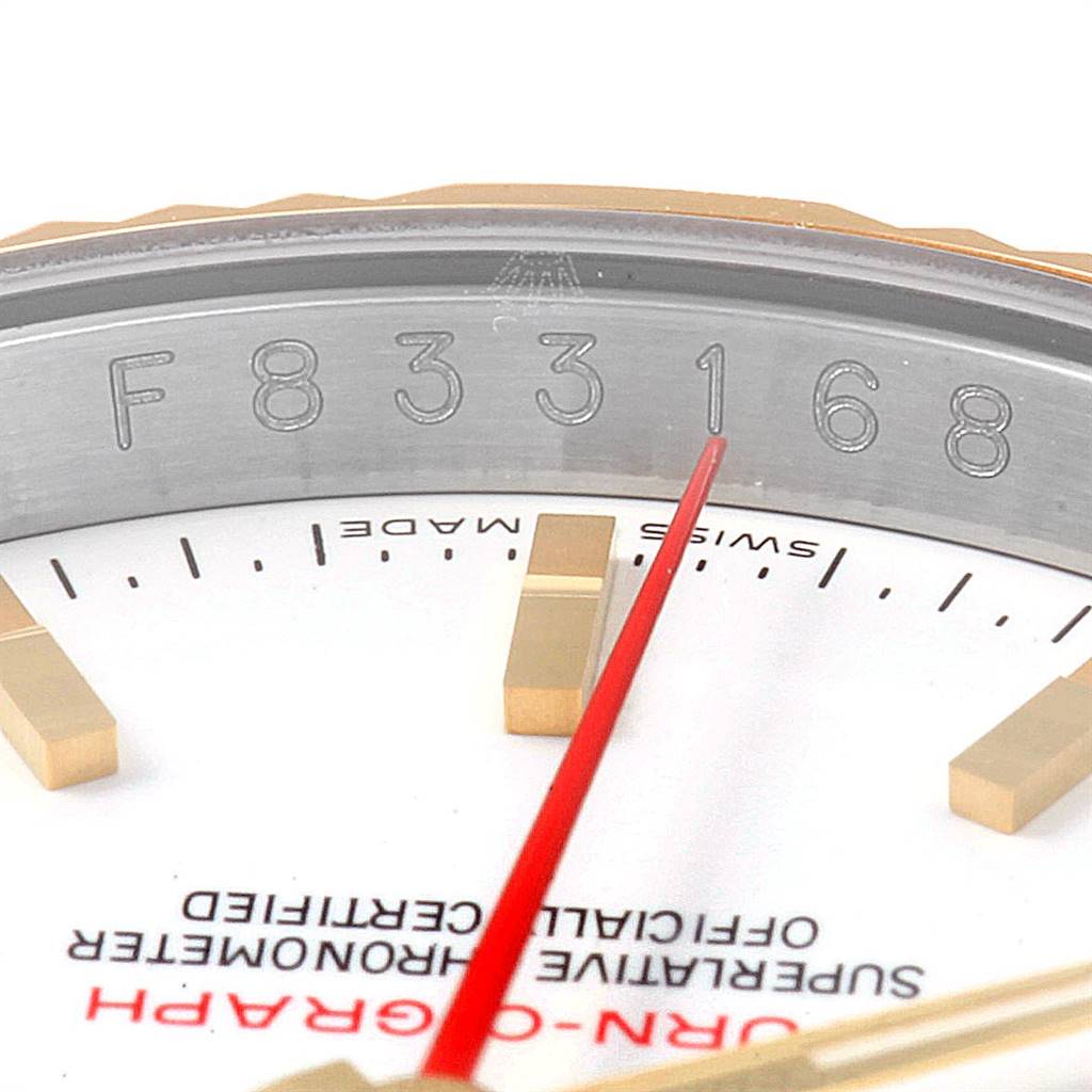 This close-up image of the Rolex Turn-o-Graph 116263 Men's Steel and Gold (two tone) White Dial 116263 Men's Steel and Gold (two tone) White Dial watch shows the serial number, part of the dial, and the second hand.