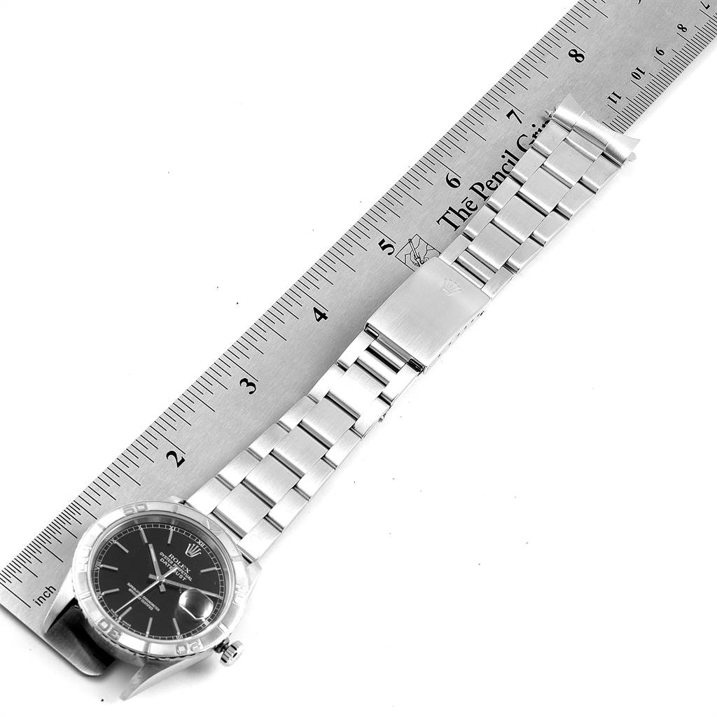 The image shows the Rolex Turn-o-Graph 16264 Men's Stainless Steel Black Dial 16264 Men's Stainless Steel Black Dial watch lying flat, displaying the face, bezel, bracelet, and clasp next to a ruler for size reference.