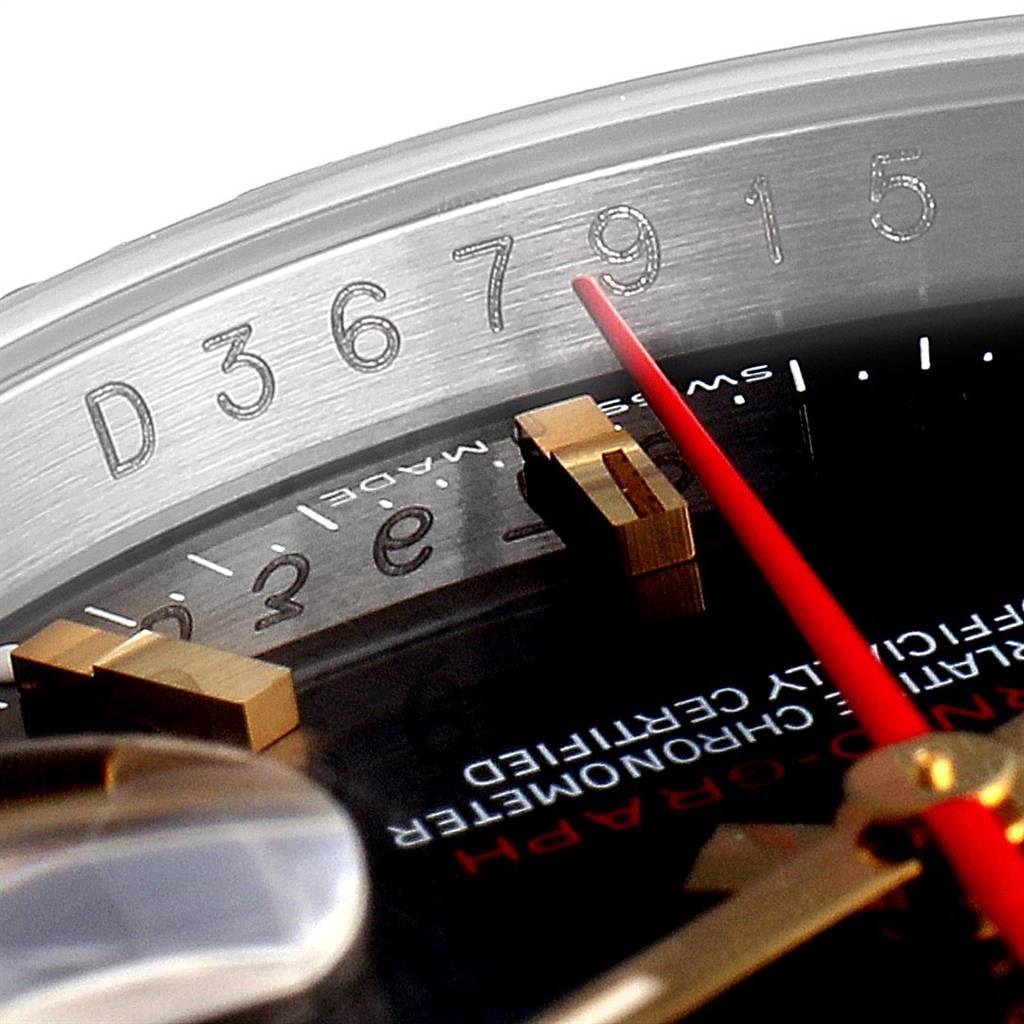 This close-up angle of the Rolex Turn-o-Graph 116263 Men
s Steel and Gold (two tone) Grey Dial 116263 Men
s Steel and Gold (two tone) Grey Dial watch showcases its serial number and partially reveals the red second hand, markers, and dial text.