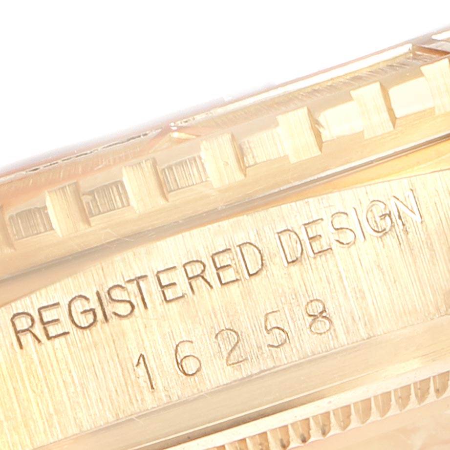 This image shows a close-up of the bezel and case side of a Rolex Turn-o-Graph 16258 Men
s Yellow Gold White Dial 16258 Men
s Yellow Gold White Dial watch, revealing the "Registered Design" inscription.