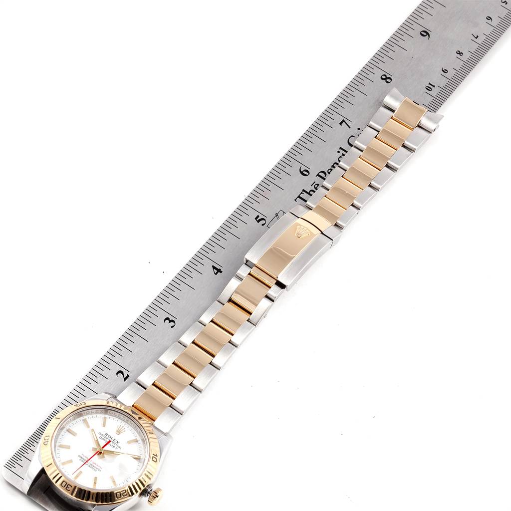 The image shows the Rolex Turn-o-Graph 116263 Men
s Stainless Steel White Dial 116263 Men
s Stainless Steel White Dial watch from the top view, highlighting the dial, bezel, and bracelet alongside a ruler for scale.