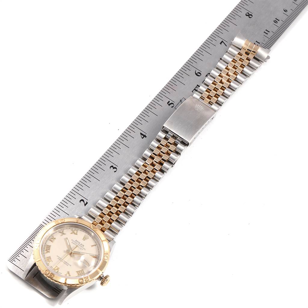 This image shows a Rolex Turn-o-Graph 16263 Men
s Steel and Gold (two tone) Beige Dial 16263 Men
s Steel and Gold (two tone) Beige Dial watch laid flat beside a ruler, displaying its face, bezel, and bracelet.