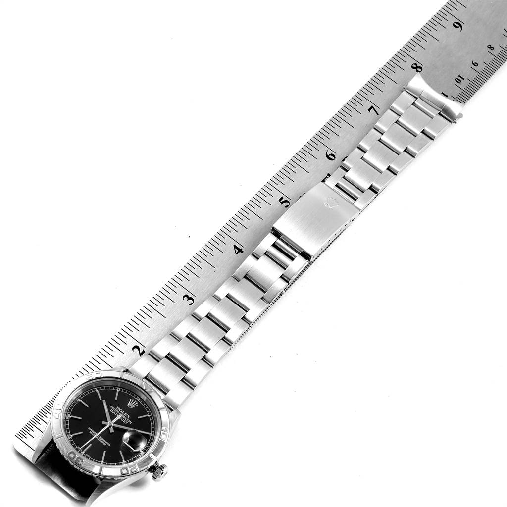 The image shows a Rolex Turn-o-Graph 16264 Men's Stainless Steel Black Dial 16264 Men's Stainless Steel Black Dial watch placed next to a ruler, displaying the watch face and the entire metal bracelet.