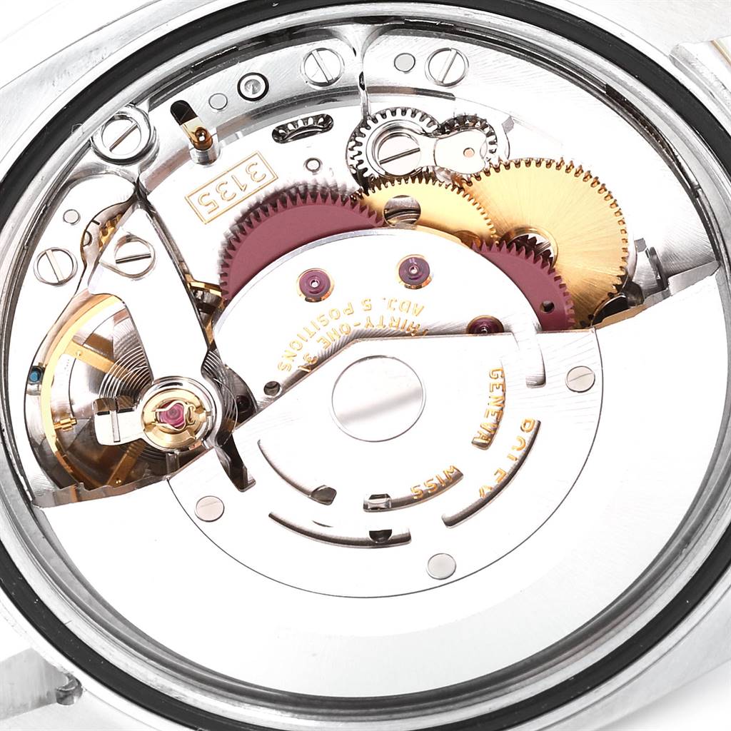 The image shows an internal view of a Rolex Turn-o-Graph 116263 Men
s Steel and Gold (two tone) Grey Dial 116263 Men
s Steel and Gold (two tone) Grey Dial watch movement, highlighting gears and mechanical components.