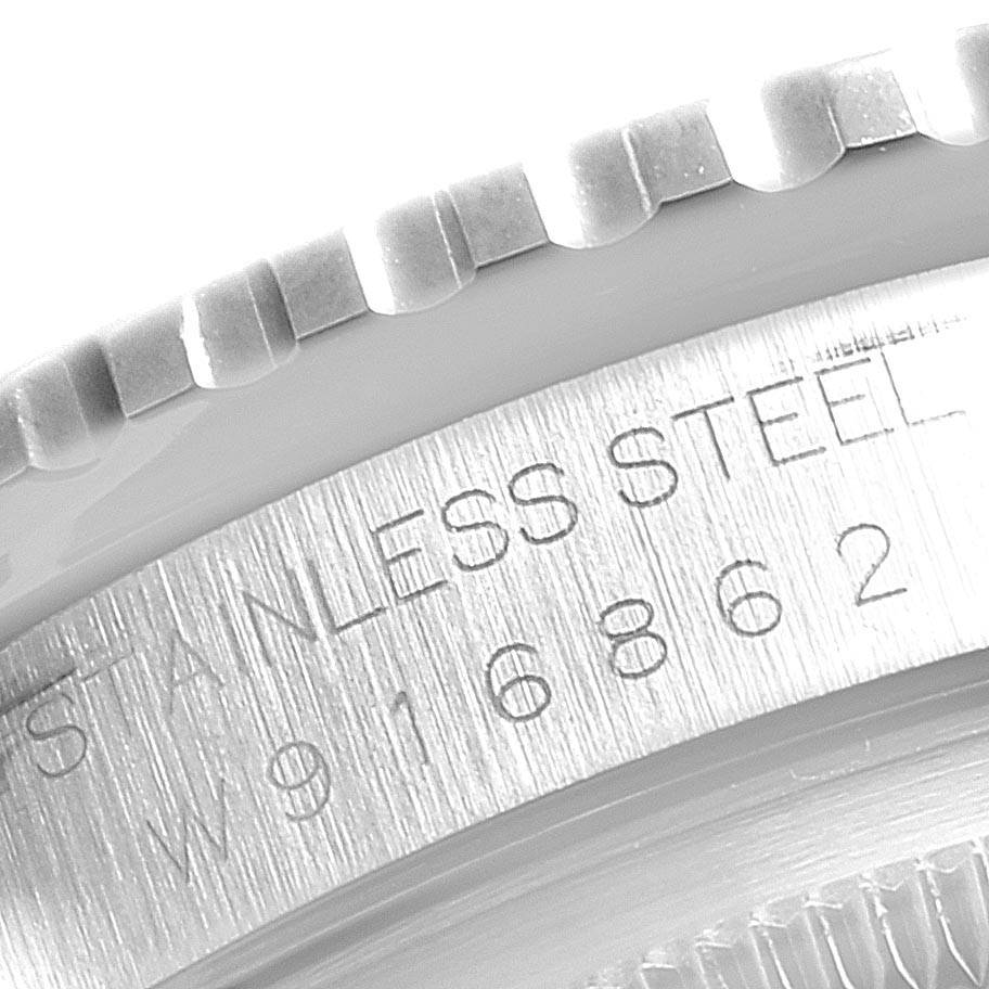 This image shows a close-up angle of the bezel and engraved serial number on the case of a Rolex Turn-o-Graph 16264 Men's Stainless Steel White Dial 16264 Men's Stainless Steel White Dial watch.