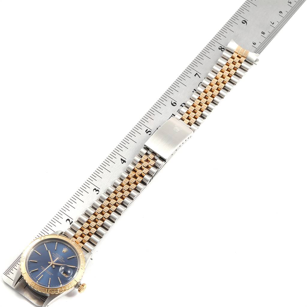 The image shows a Rolex Turn-o-Graph 16253 Men
s Steel and Gold (two tone) Blue Dial 16253 Men
s Steel and Gold (two tone) Blue Dial watch with its face and bracelet laid flat against a ruler for measurement.