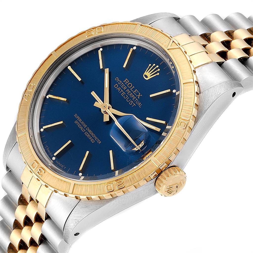 The image shows a Rolex Turn-o-Graph 16253 Men
s Steel and Gold (two tone) Blue Dial 16253 Men
s Steel and Gold (two tone) Blue Dial watch at an angle displaying the face, bezel, crown, and part of the bracelet.