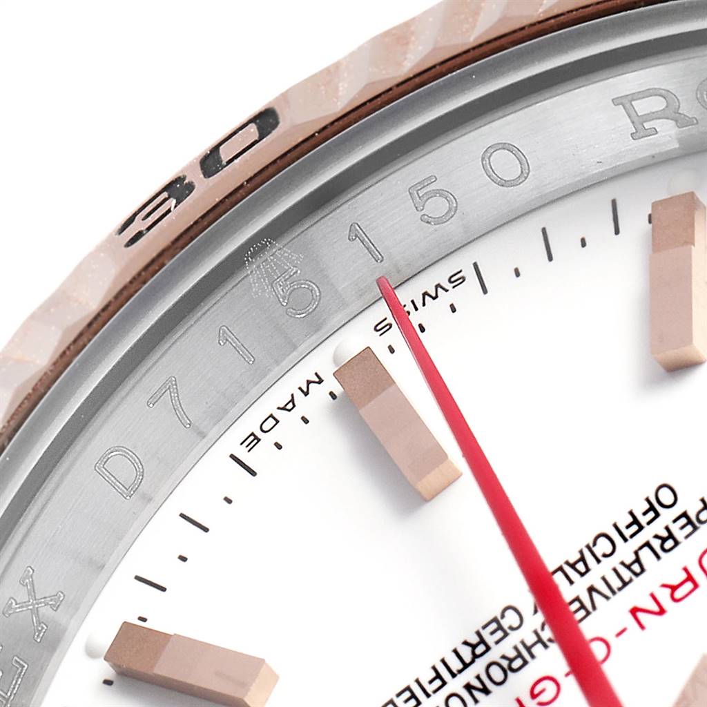 This close-up image of the Rolex Turn-o-Graph 116261 Men's Stainless Steel White Dial 116261 Men's Stainless Steel White Dial watch shows the bezel, some indices, a red second hand, and part of the dial text.