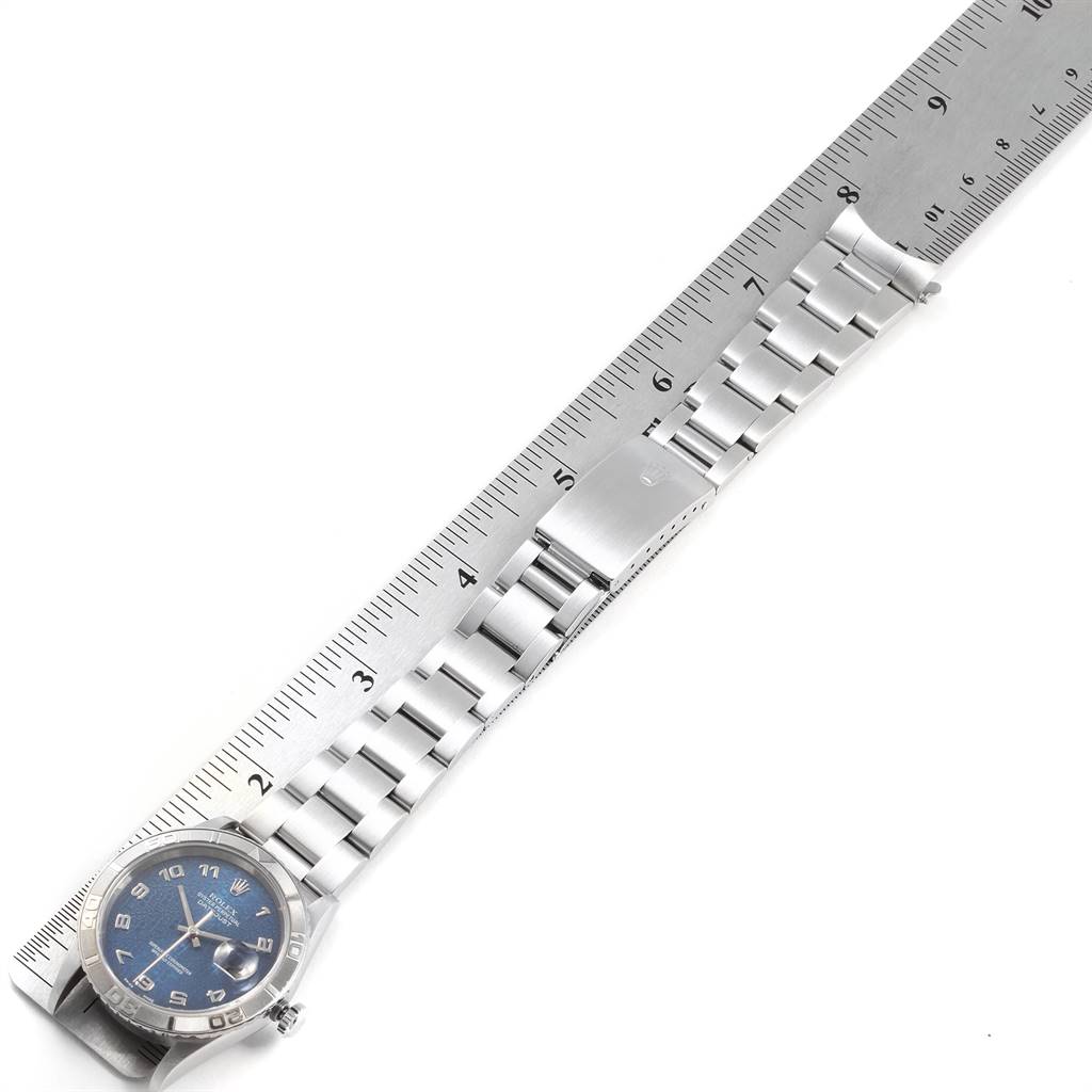 The image shows a Rolex Turn-o-Graph 16264 Men
s Stainless Steel Blue Dial 16264 Men
s Stainless Steel Blue Dial watch, laid flat with the band and face visible, next to a ruler for scale.