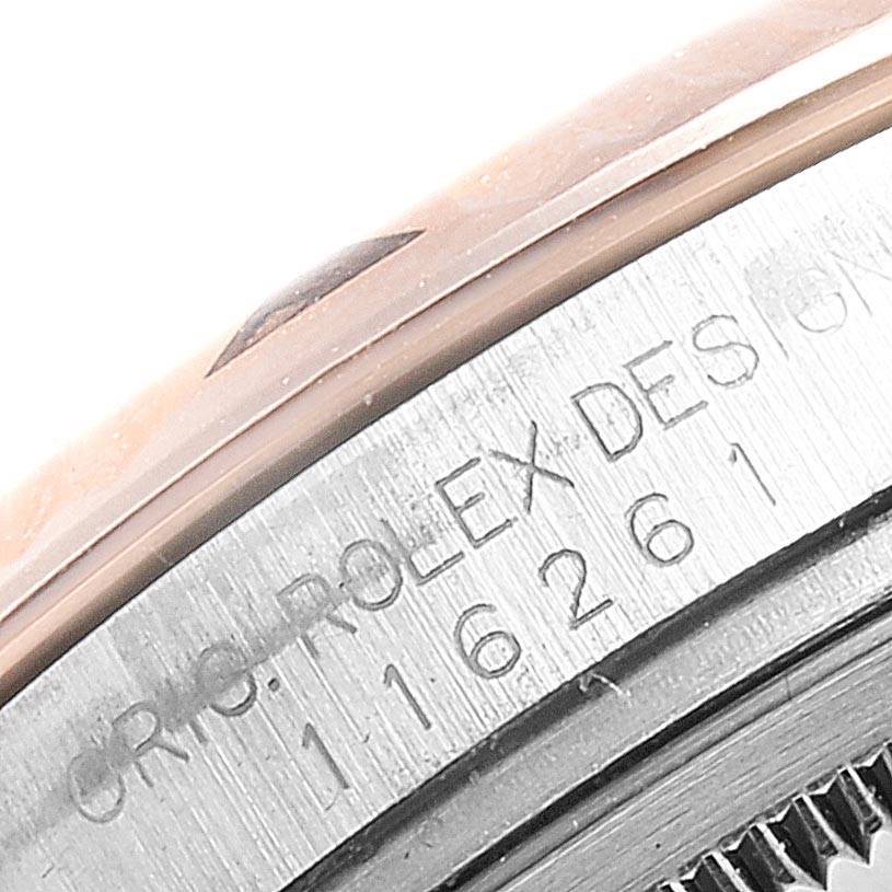 This image shows a close-up of the engraved serial number and brand name on the side of a Rolex Turn-o-Graph 116261 Men's Steel and Gold (two tone) Black Dial 116261 Men's Steel and Gold (two tone) Black Dial watch case.