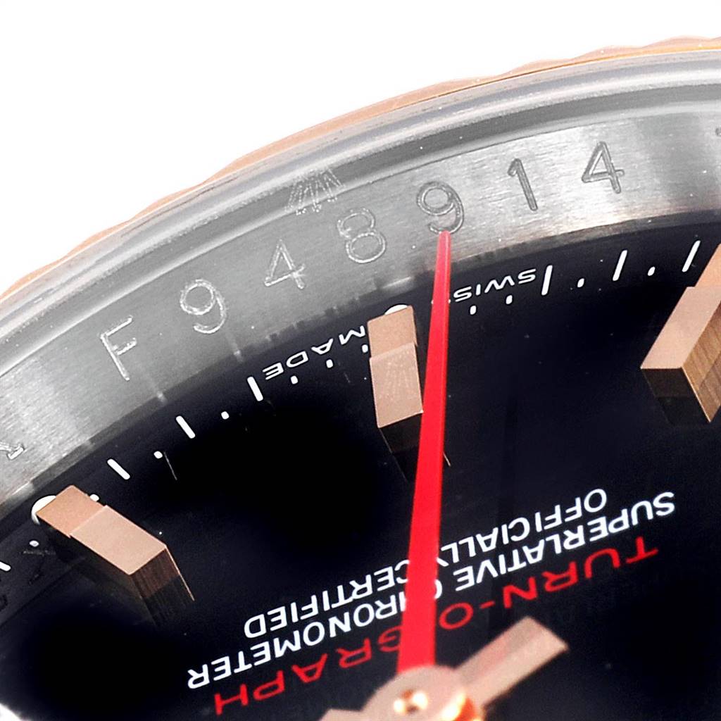 The image shows a close-up of the Rolex Turn-o-Graph 116261 Men's Steel and Gold (two tone) Black Dial 116261 Men's Steel and Gold (two tone) Black Dial watch, including part of the dial, hands, and serial number.