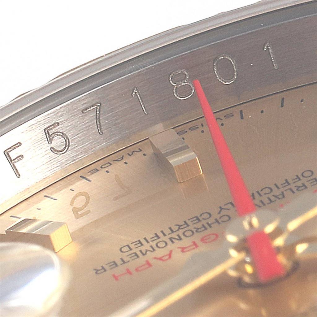 This close-up image of a Rolex Turn-o-Graph 116263 Men
s Steel and Gold (two tone) Champagne Dial 116263 Men
s Steel and Gold (two tone) Champagne Dial watch model displays the engraved serial number and part of the dial and red second hand.