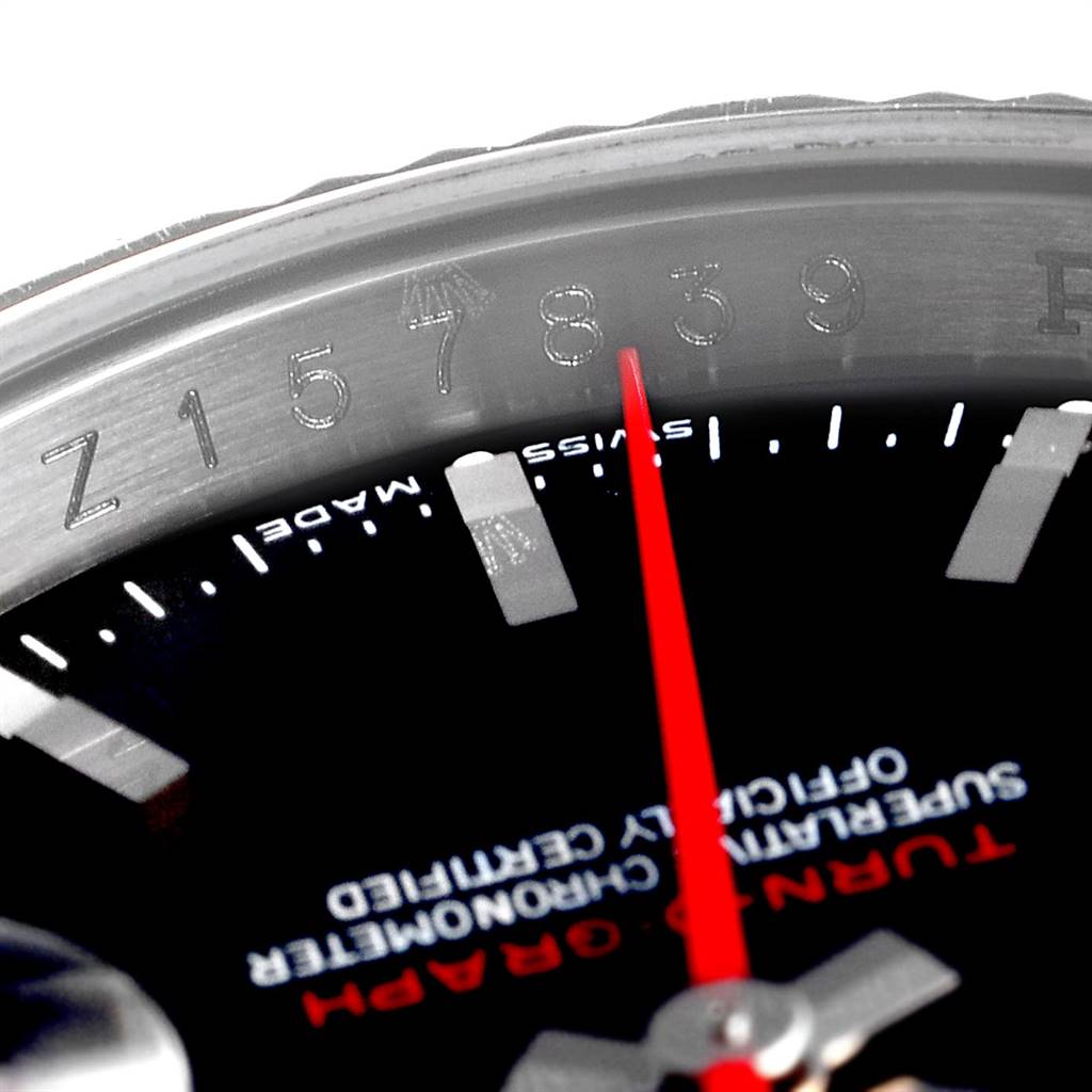 This close-up image of a Rolex Turn-o-Graph 116264 Men's Stainless Steel Black Dial 116264 Men's Stainless Steel Black Dial watch focuses on the bezel's serial number, red second hand, and part of the dial.