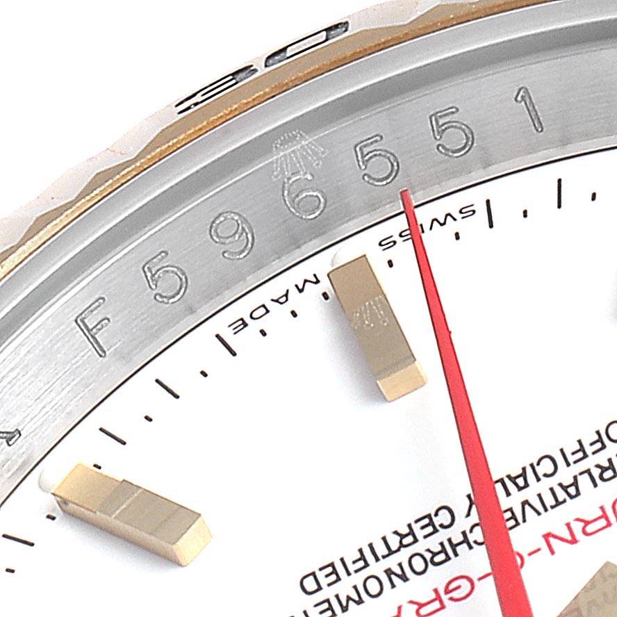 This close-up of the Rolex Turn-o-Graph 116263 Men
s Steel and Gold (two tone) White Dial 116263 Men
s Steel and Gold (two tone) White Dial watch shows part of the bezel, dial, and red second hand.
