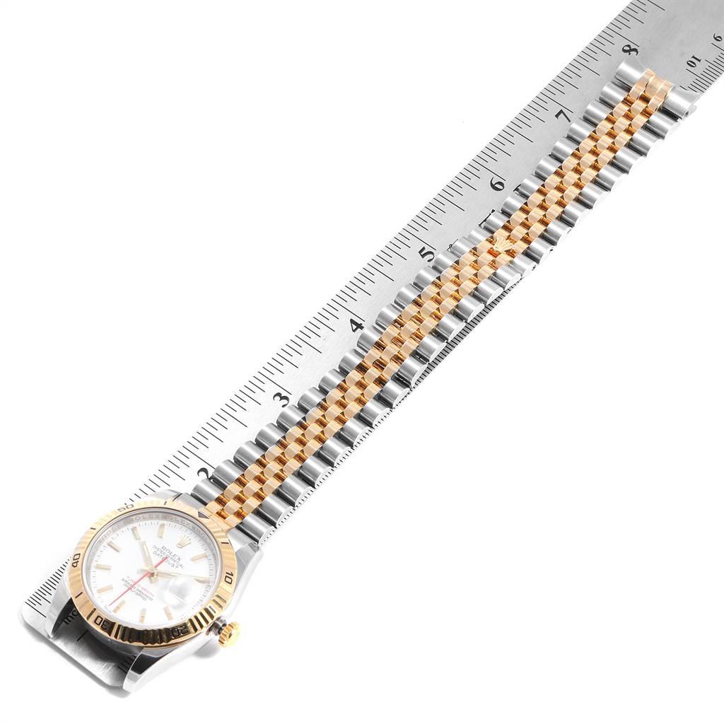 The Rolex Turn-o-Graph 116263 Men
s Stainless Steel White Dial 116263 Men
s Stainless Steel White Dial watch is shown from an overhead angle featuring the face, bezel, and bracelet beside a ruler for scale.