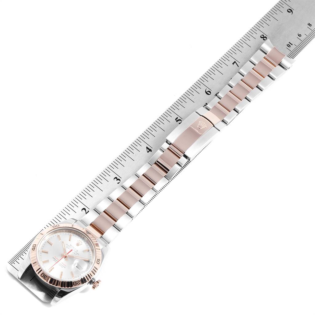 The image shows a top-down view of the Rolex Turn-o-Graph 116261 Men's Steel and Gold (two tone) Silver Dial 116261 Men's Steel and Gold (two tone) Silver Dial watch, including its face, bezel, crown, and part of its bracelet with a ruler for scale.