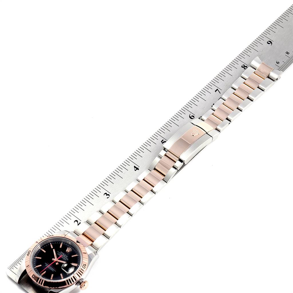 This image shows a side angle of a Rolex Turn-o-Graph 116261 Men
s Stainless Steel Black Dial 116261 Men
s Stainless Steel Black Dial watch with its face, bezel, and bracelet fully visible, measured against a ruler.