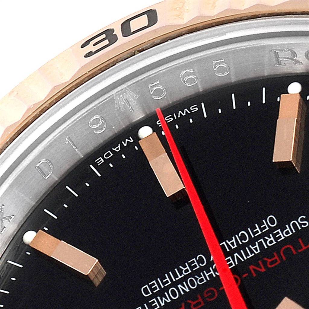 The close-up image shows the Turn-o-Graph model by Rolex, focusing on part of the bezel, markers, and dial.
