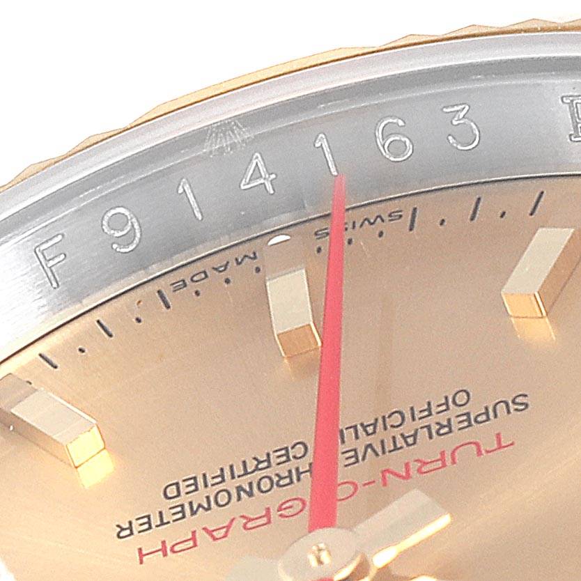 This close-up image of the Rolex Turn-o-Graph 116263 Men
s Stainless Steel Champagne Dial 116263 Men
s Stainless Steel Champagne Dial watch shows part of the bezel, serial number, and dial with hands and markers.