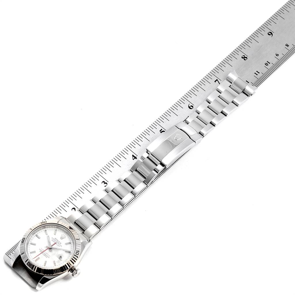 The image shows a Rolex Turn-o-Graph 116264 Men
s Stainless Steel White Dial 116264 Men
s Stainless Steel White Dial watch with its bracelet laid flat next to a ruler for scale.