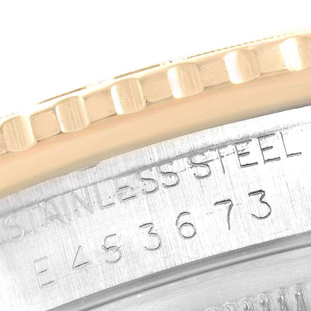 This close-up image of the Rolex Turn-o-Graph 16263 Men
s Steel and Gold (two tone) Champagne Dial 16263 Men
s Steel and Gold (two tone) Champagne Dial shows part of the bezel and stainless steel case, along with some engraved serial numbers.
