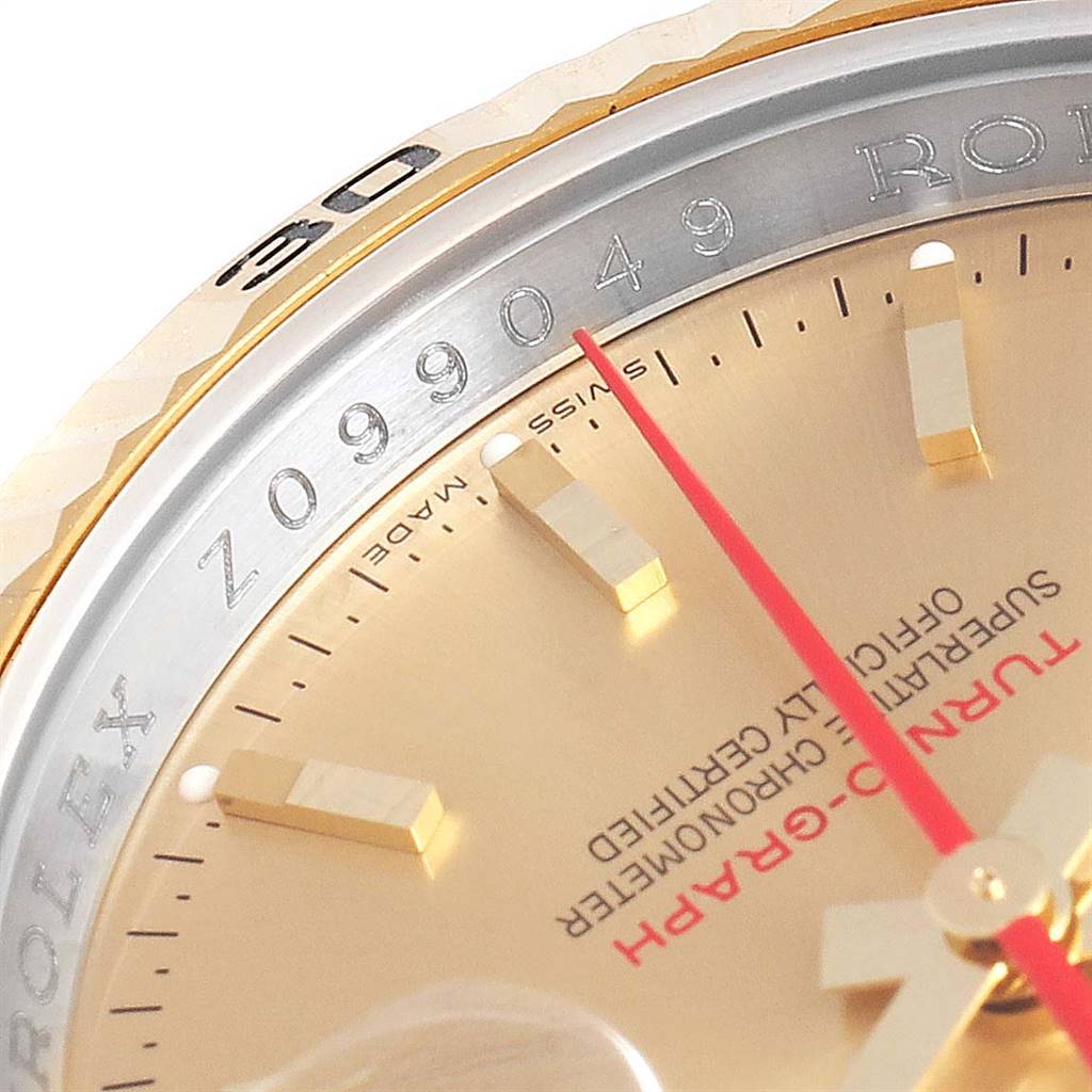The close-up image of the Rolex Turn-o-Graph 116263 Men's Stainless Steel Champagne Dial 116263 Men's Stainless Steel Champagne Dial watch shows part of the dial, bezel, red seconds hand, and serial number.