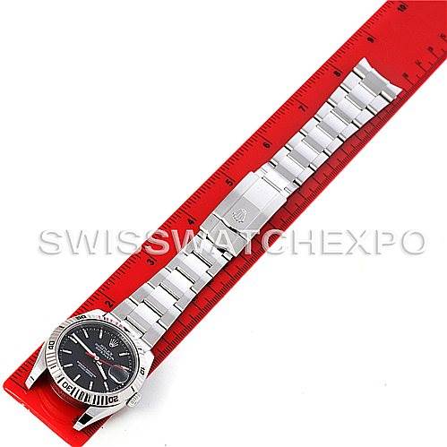 This image shows a Rolex Turn-o-Graph 116264 Men's Stainless Steel Black Dial 116264 Men's Stainless Steel Black Dial watch laid flat next to a red ruler, displaying the face, bezel, and bracelet in full view.