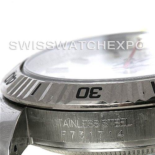 The image shows a close-up of the bezel and part of the case of a Rolex Turn-o-Graph 116264 Men's Stainless Steel White Dial 116264 Men's Stainless Steel White Dial watch, focusing on its engravings and stainless steel casing.