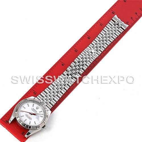 The Rolex Turn-o-Graph 116264 Men's Stainless Steel White Dial 116264 Men's Stainless Steel White Dial watch is displayed from a top-down angle, with its full-length stainless steel bracelet stretched out beside a red ruler.