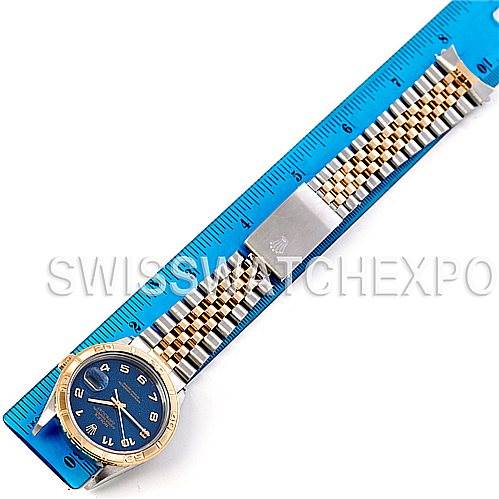 The image shows a Rolex Turn-o-Graph 16263 Men's Steel and Gold (two tone) Blue Dial 16263 Men's Steel and Gold (two tone) Blue Dial watch placed next to a blue ruler, displaying the face, bezel, and bracelet of the watch.