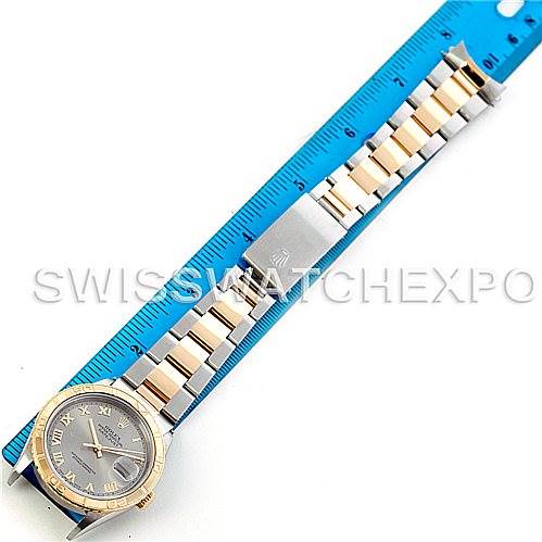 This image shows the front view of a Rolex Turn-o-Graph 16263 Men's Steel and Gold (two tone) Grey Dial 16263 Men's Steel and Gold (two tone) Grey Dial watch with a measuring ruler placed alongside it.