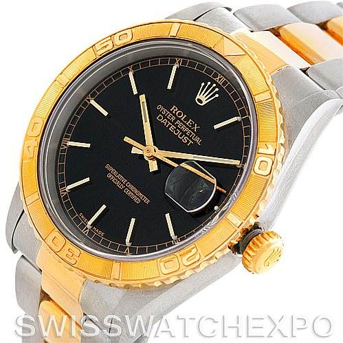 This image shows the face, bezel, crown, and part of the bracelet of a Rolex Turn-o-Graph 16263 Men's Steel and Gold (two tone) Black Dial 16263 Men's Steel and Gold (two tone) Black Dial watch.