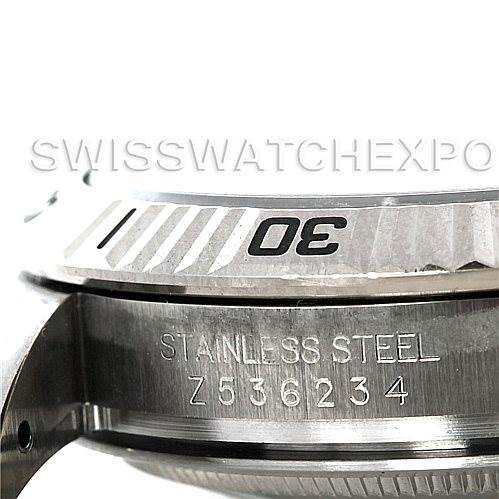 This close-up image shows the stainless steel bezel and part of the casing of a Rolex Turn-o-Graph 116264 Men's Stainless Steel Black Dial 116264 Men's Stainless Steel Black Dial watch.