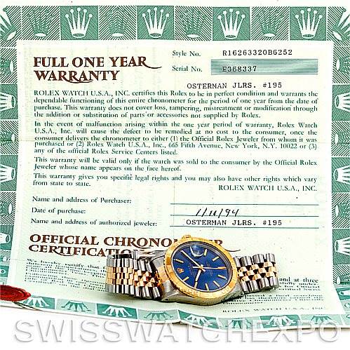 The image shows a Rolex Turn-o-Graph 16263 Men's Steel and Gold (two tone) Blue Dial 16263 Men's Steel and Gold (two tone) Blue Dial watch from a top-down angle, with its face, bezel, and bracelet visible alongside warranty documents.