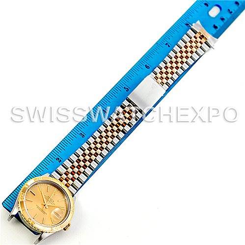 The Rolex Turn-o-Graph 16263 Men's Steel and Gold (two tone) Champagne Dial 16263 Men's Steel and Gold (two tone) Champagne Dial watch is shown from a top-down angle with a blue ruler measuring its bracelet length.