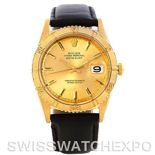 The image shows the Rolex Turn-o-Graph 1625 Men's Yellow Gold Champagne Dial 1625 Men's Yellow Gold Champagne Dial watch from a front angle, highlighting its gold dial, bezel, and black leather strap.