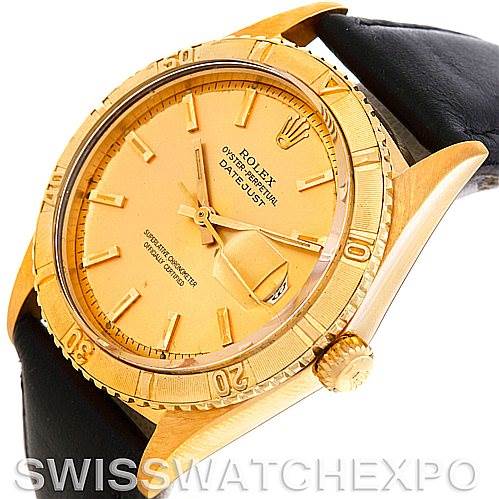 The image shows a gold Rolex Turn-o-Graph 1625 Men's Yellow Gold Champagne Dial 1625 Men's Yellow Gold Champagne Dial Datejust model watch at an oblique angle, highlighting its dial, bezel, crown, and leather strap.