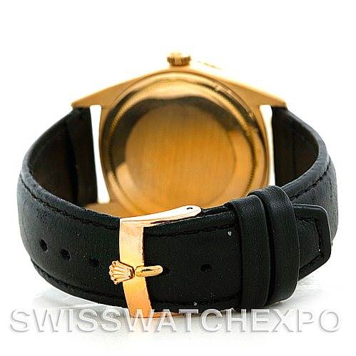 The image shows the back view of the Rolex Turn-o-Graph 1625 Men's Yellow Gold Champagne Dial 1625 Men's Yellow Gold Champagne Dial model, focusing on the case back and the leather strap with a gold buckle.