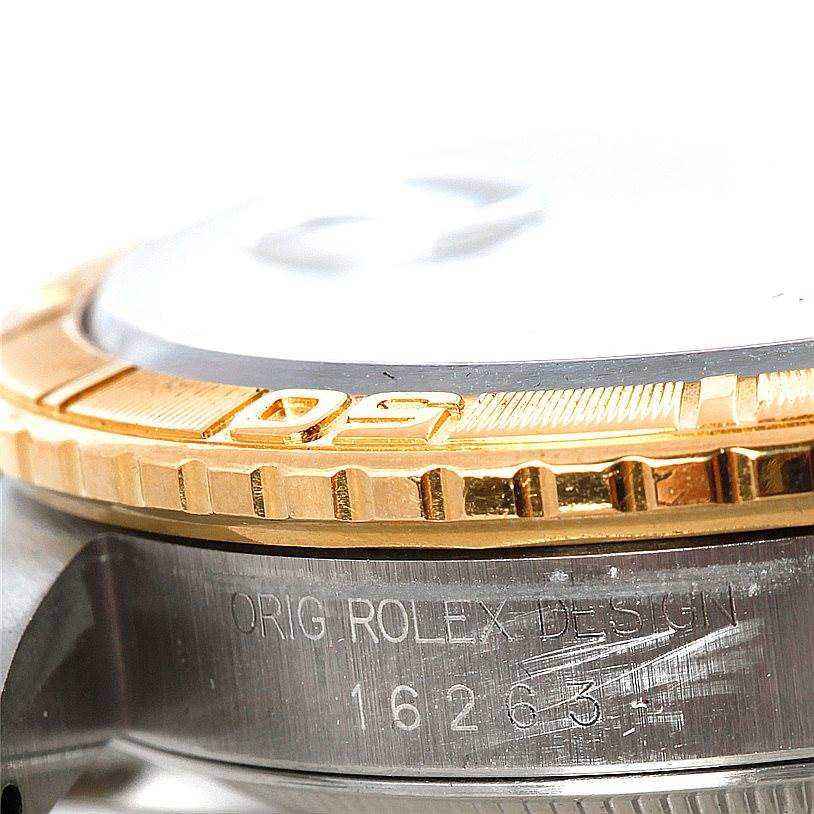 This close-up image of a Rolex Turn-o-Graph 16263 Men's Steel and Gold (two tone) White Dial 16263 Men's Steel and Gold (two tone) White Dial watch shows the gold bezel and part of the case with model number 16263 engraved.