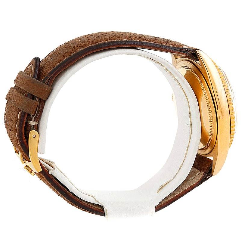 This image shows a side view of a Rolex Turn-o-Graph 1625 Men's Yellow Gold Champagne Dial 1625 Men's Yellow Gold Champagne Dial watch, highlighting its brown leather strap and gold case.