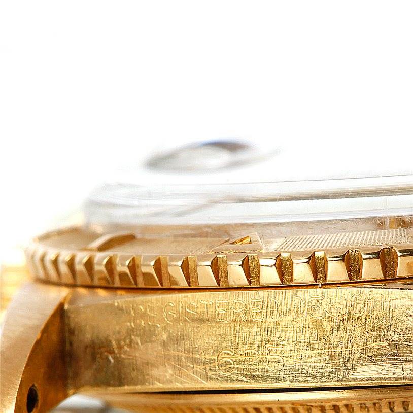 This close-up image of the Rolex Turn-o-Graph 1625 Men's Yellow Gold Champagne Dial 1625 Men's Yellow Gold Champagne Dial watch shows the edge of the bezel and part of the case.