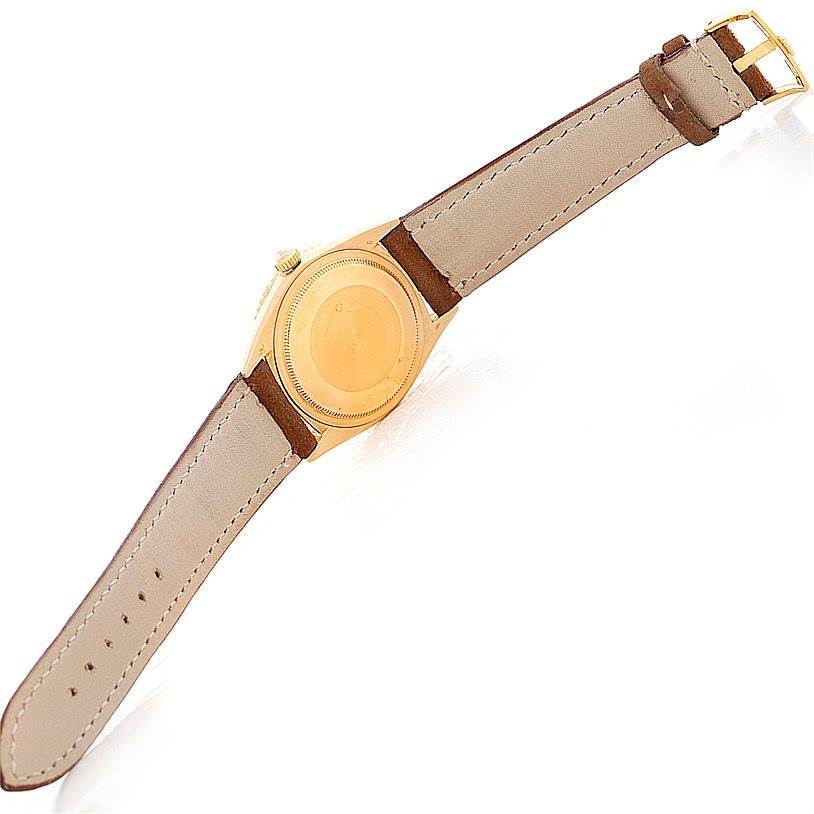 The image shows the back view of the Rolex Turn-o-Graph 1625 Men's Yellow Gold Champagne Dial 1625 Men's Yellow Gold Champagne Dial watch, displaying the case back, crown, and leather strap.