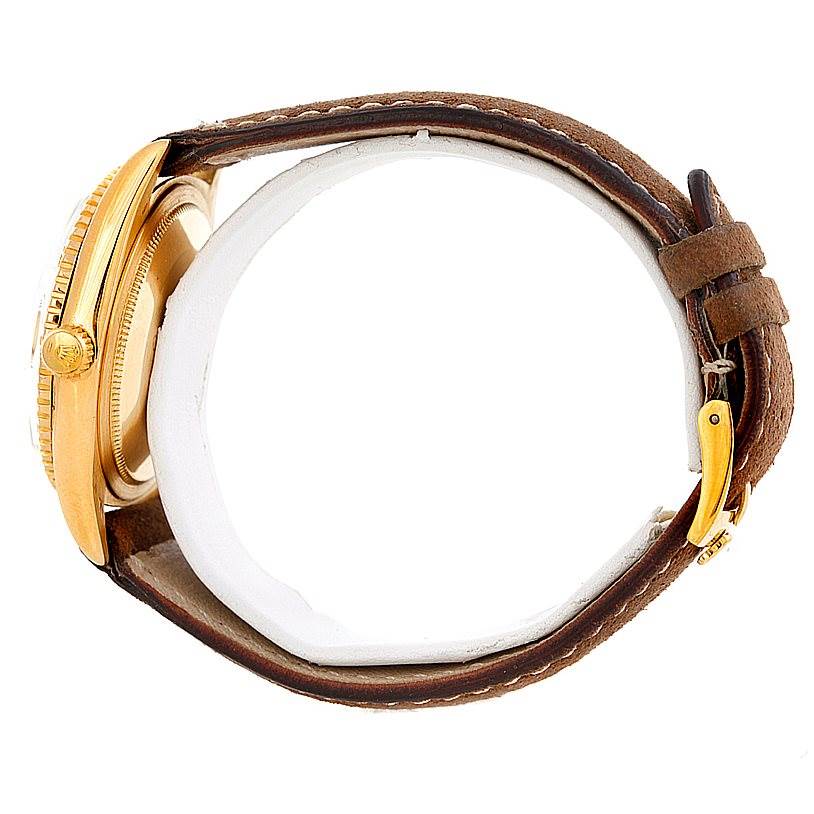 This image shows a side view of a Rolex Turn-o-Graph 1625 Men's Yellow Gold Champagne Dial 1625 Men's Yellow Gold Champagne Dial watch, highlighting its brown leather strap and gold case.