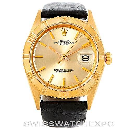 The image shows a front view of the Rolex Turn-o-Graph 1625 Men's Yellow Gold Champagne Dial 1625 Men's Yellow Gold Champagne Dial watch, showcasing its gold bezel, gold dial, date window, and black leather strap.