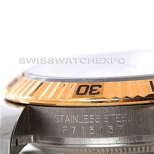 This image shows a close-up of the gold bezel and serial number on a Rolex Turn-o-Graph 116263 Men's Stainless Steel White Dial 116263 Men's Stainless Steel White Dial model watch, highlighting its stainless steel construction.