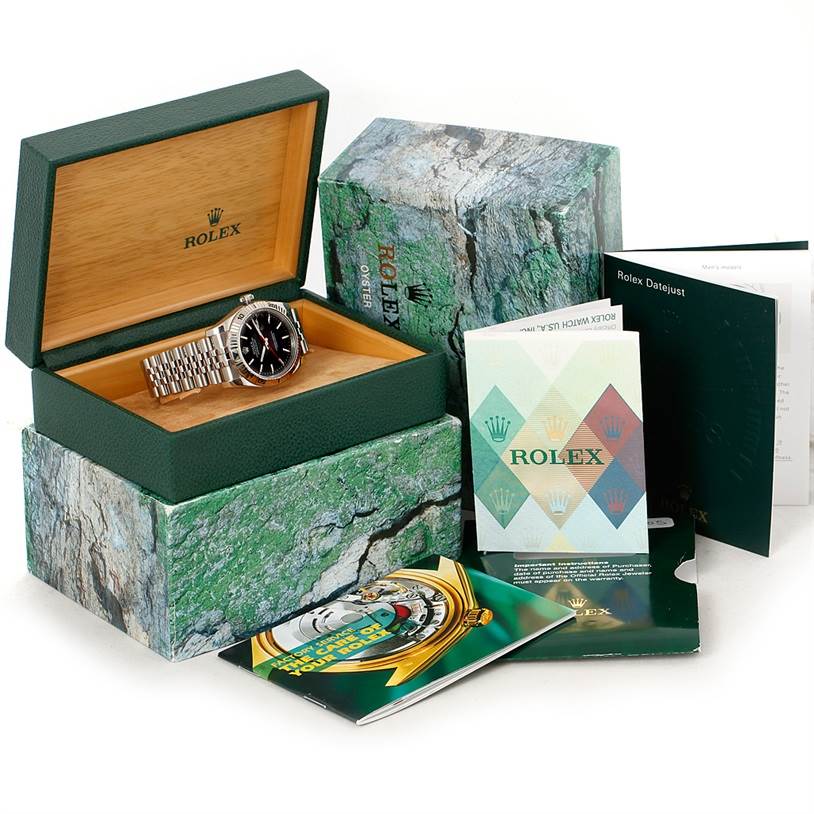 The image shows a Rolex Turn-o-Graph 116264 Men
s Stainless Steel Black Dial 116264 Men
s Stainless Steel Black Dial watch in an open box, along with its packaging and booklets.