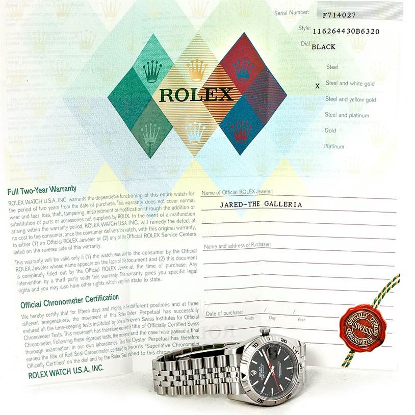 The image shows a Rolex Turn-o-Graph 116264 Men
s Stainless Steel Black Dial 116264 Men
s Stainless Steel Black Dial watch placed on its warranty and certification documents with the face and bracelet prominently displayed.