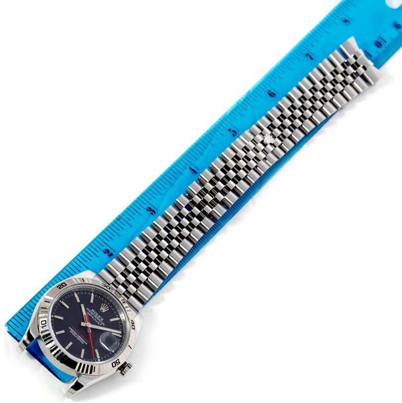 The image shows the face and bracelet of the Rolex Turn-o-Graph 116264 Men
s Stainless Steel Black Dial 116264 Men
s Stainless Steel Black Dial watch, positioned alongside a blue ruler for scale.