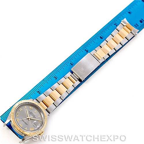 This image shows an overhead view of the Rolex Turn-o-Graph 16263 Men's Steel and Gold (two tone) Grey Dial 16263 Men's Steel and Gold (two tone) Grey Dial watch, displaying its face, two-tone bracelet, clasp, and a ruler for size reference.