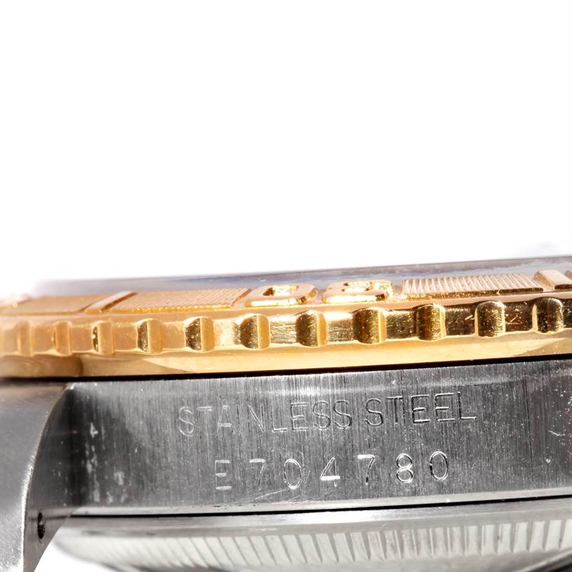 The image shows a close-up side view of the bezel and case of a Rolex Turn-o-Graph 16263 Men's Steel and Gold (two tone) Black Dial 16263 Men's Steel and Gold (two tone) Black Dial watch, focusing on the serial number and "STAINLESS STEEL" engraving.